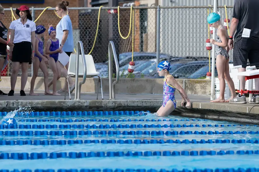 Brian FitzGerald coaching a young swimmer at poolside