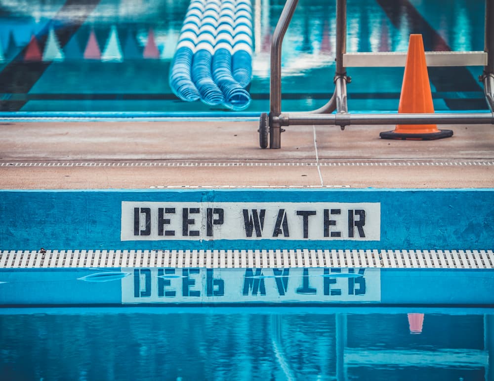 Adult swimmer getting one-to-one coaching in a pool