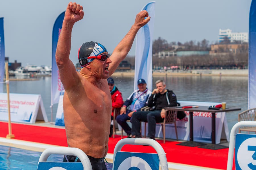 Triathlete swimming front crawl at competition pool